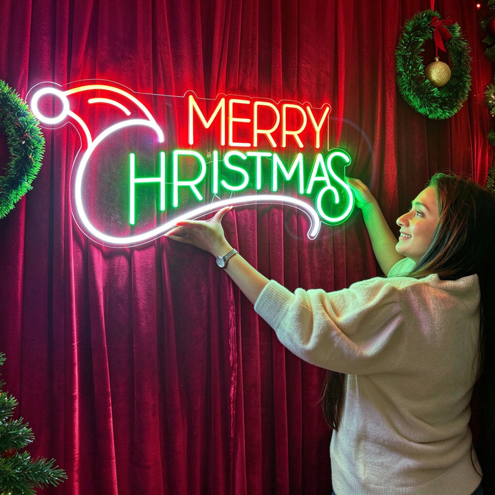 Newlyweds holding a wedding neon sign